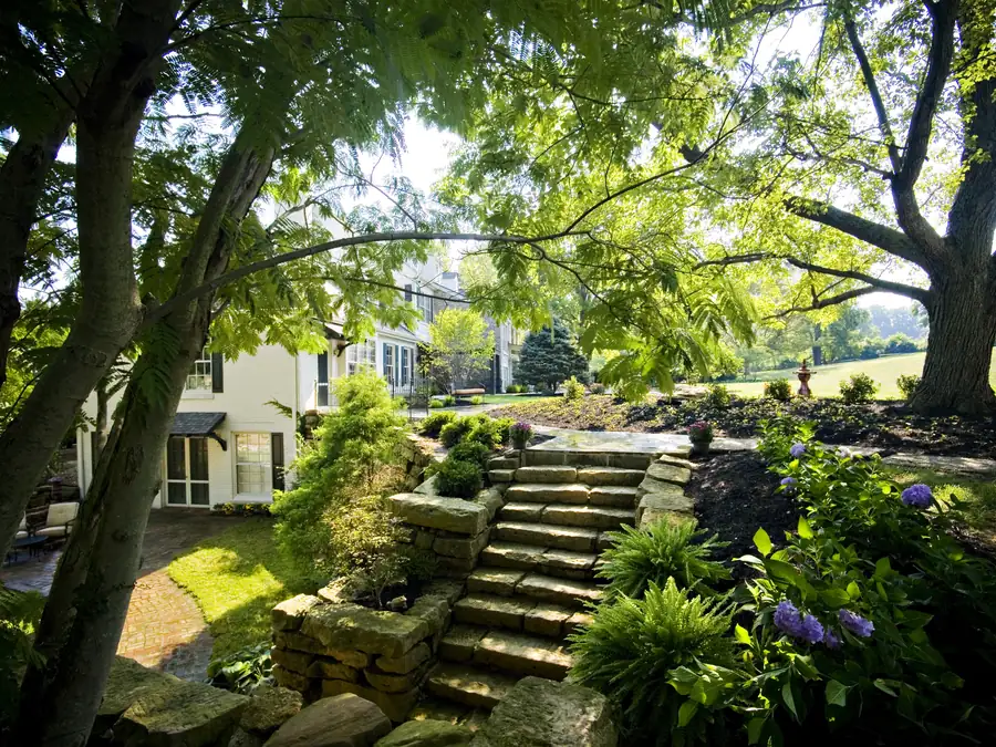 Stone steps and planted gardens beside the estate house.
